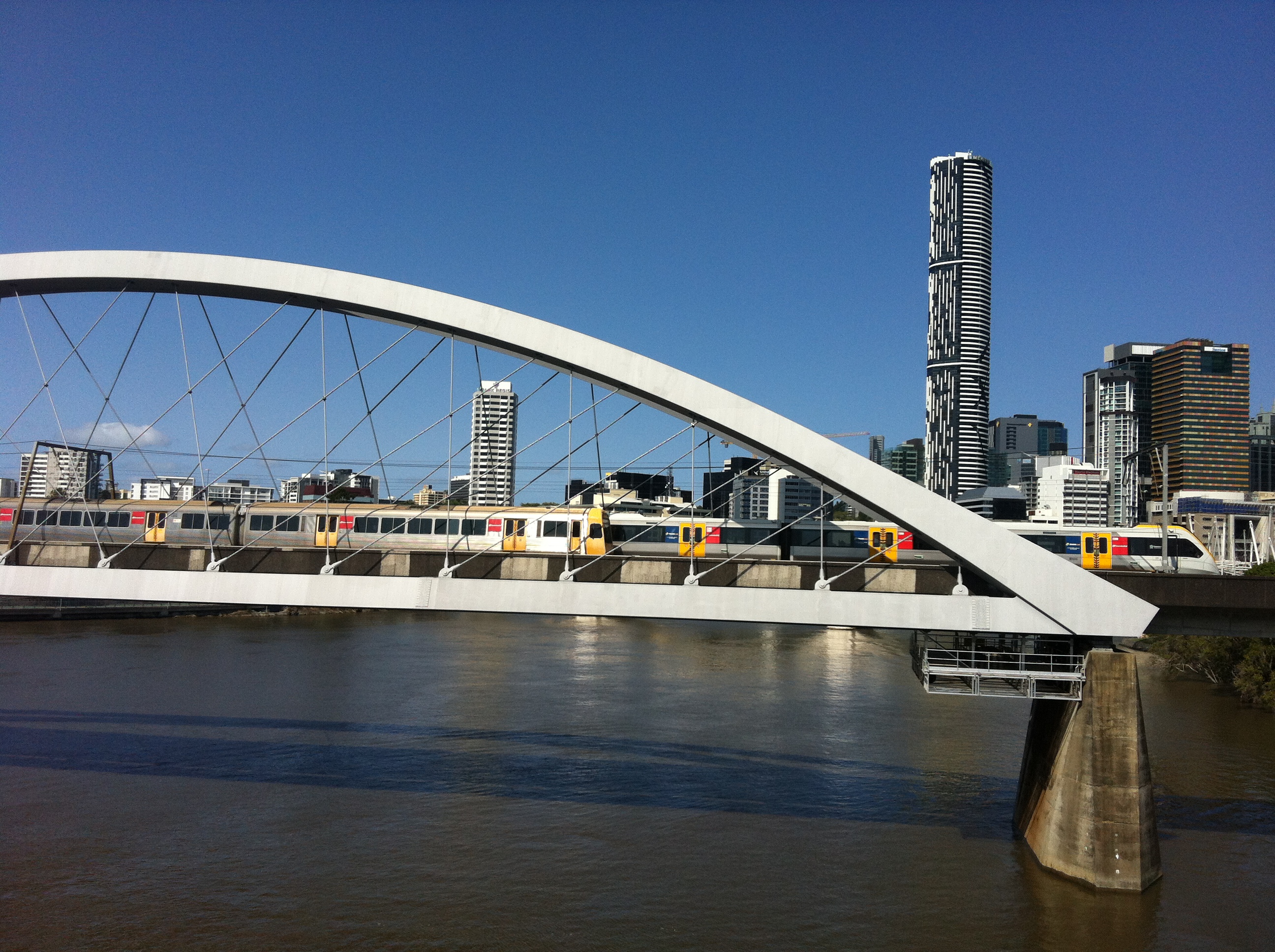Two trains passing each other on the Merrivale bridge over the Brisbane river.